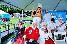 Lily K. Donaldson and three women who worked in shipyards during WW2 hold up their arms like Rosie the Riveter