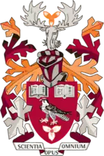 Coat of Arms of Mohawk College with primarily burgundy, crimson, and orange colours