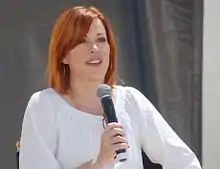 Ringwald holding a microphone