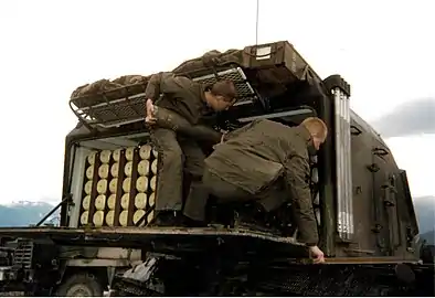 Soldiers loading shells in the ammunition racks at the rear of the turret, near Mostar