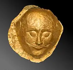 Gold male death-mask made of sheet metal with repoussé details portraying the deceased's eyes opened, the only one in Shaft Grave IV