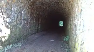 Inside the tunnel with a niche on the left.