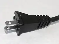 One blade is wider on a polarized 1-15P plug.