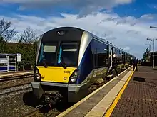 Passengers board train 4002, waiting at a platform at Holywood railway station.