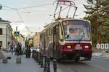 Red-and-white tram on a city street