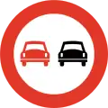 No overtakingRestriction is for overtaking motor vehicles with more than two wheels. Overtaking on the right side is permitted by normal traffic rules.