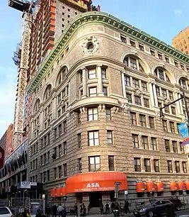 The New York and New Jersey Telephone and Telegraph Building, an eight-story brick-terracotta-limestone building, as seen from ground level on a sunny day