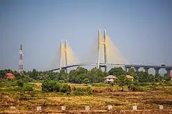 Bridge seen from a distance with a field in the foreground.