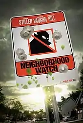 Red-and-white neighborhood-watch sign on a post