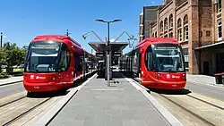 An eastbound CAF Urbos 100 at Civic stop