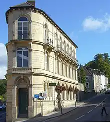 Italianate three-storey building, with entrance at the narrow end of the building nearest the camera