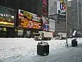 Times Square, NYC, during the February 2003 winter storm. Image shows the city garbage collection trucks outfitted with snow plows and scoops.