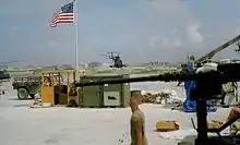 Military airfield, large gun in foreground