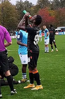 Omar Browne drinking from a bottle of water