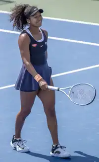 Osaka smiling as she walks across the court