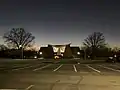 Looking at the entrance of St. Vincent Pallotti Church with the church/school parking lot in the foreground.