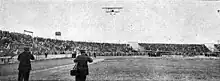 French aviator Marcel Paillette about to land on the stadium, 1912