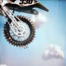 The back of a BMX bike in mid-air