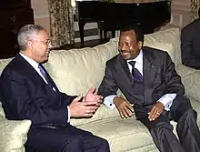 Colin Powell and Cameroon president Paul Biya, smiling and talking