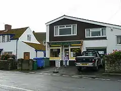 modern building with shop. Sign over window says Pawlett Country Store & Off Licence.