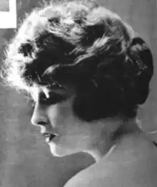 A young white woman with coiffed hair, in near-profile