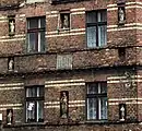 Facade of an old tenement house with figurines of Holy Mary