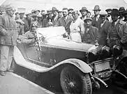 Giuseppe Campari on Alfa Romeo 6C 1750 Compressore; standing in centre (from left) Enzo Ferrari and Achille Varzi