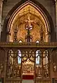 The screen designed by Bodley (1906), who also designed the organ case and reredos