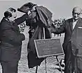 Unveiling of Plaque during halftime of dedication game.  Millard Roberts on left, Harry Blum on right