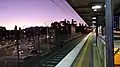 Westbound view from Platform 1 in January 2021. The junction of Punt Road and Olympic Boulevard is to the left, with AAMI Park in the distance.