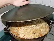 Plov cooking in a kazan.