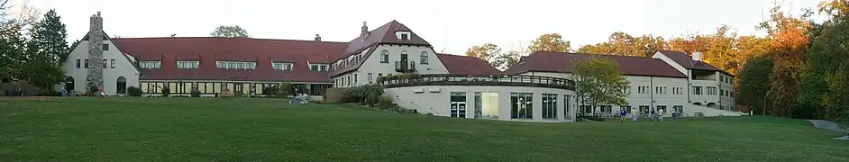 Historic structure to the left, pool additions with 21st-century addition to the right.