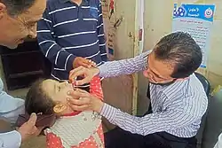  A child receiving drops of polio vaccine in her mouth