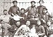 Poloz Mukuch (in the centre with dhol) and Tsitro Alek (second from the left on the bottom) with their musical band.