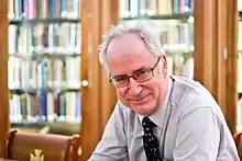 Dr. Simon Wessely sitting at a table