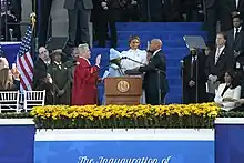 Moore takes the oath of office at his public swearing in with his wife and children