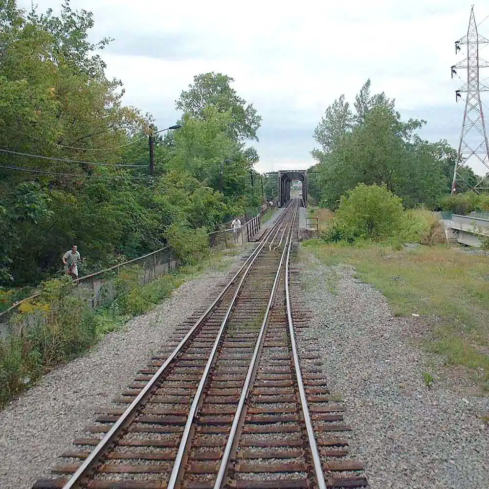 CPR's Bordeaux Railway Bridge gauntlet track in Montreal, Quebec. The bridge is visible in the background. The bicycle trail