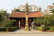 Stone Dhvaja stands in front of the Hall of Manjushri.