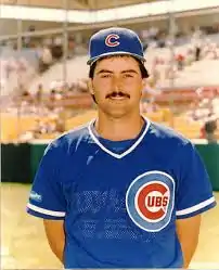 A man in a blue baseball jersey and cap