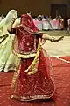 Woman performing folk dance in ghoonghat.