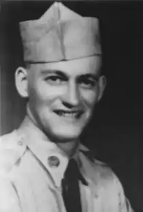 A head shot of a young soldier smiling towards the camera.