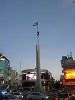 Monument and Palestinian flag at Al Sa’a Square/Yasser Arafat Square in Ramallah