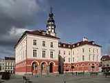 Grodków Town Hall with a fountain.