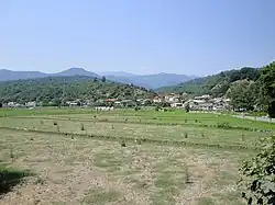 Photograph of fields with the village in the background