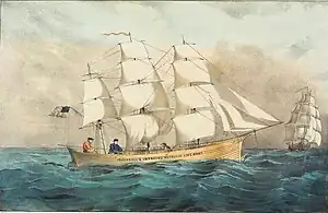 Three-masted sailing ship at sea in full sail