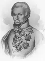 Black and white print of a man whose hair is combed back and who appears to have an injury to his right eye. He wears a white military uniform with numerous awards pinned to the left breast.