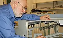 Richard Brett with a model of the Queen Elizabeth Hall at the Southbank Centre, London