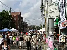 large group of people walking along street