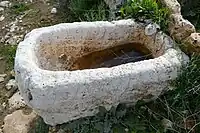 A stone structure with water at Hurvat Teena