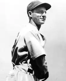 A man in a light jersey and dark cap